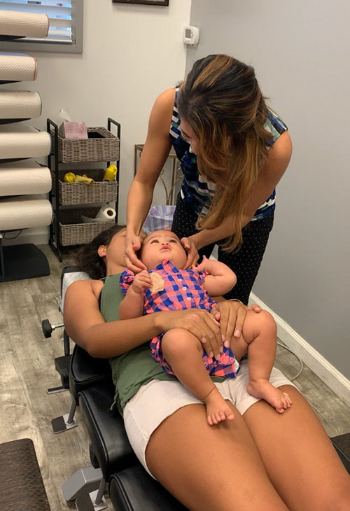 Chiropractor Ewa Beach HI Charlene Poderoso Calio Adjusting Little Girl